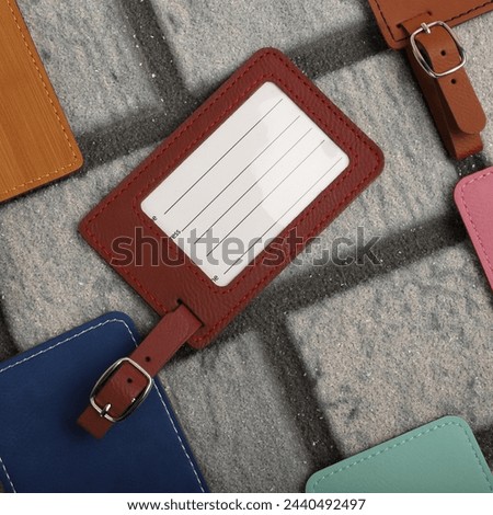Leather luggage tags in different colors. Concept shot, top view. Custom background, luggage tags view. Empty Travel Luggage Label, Space blank for text.	