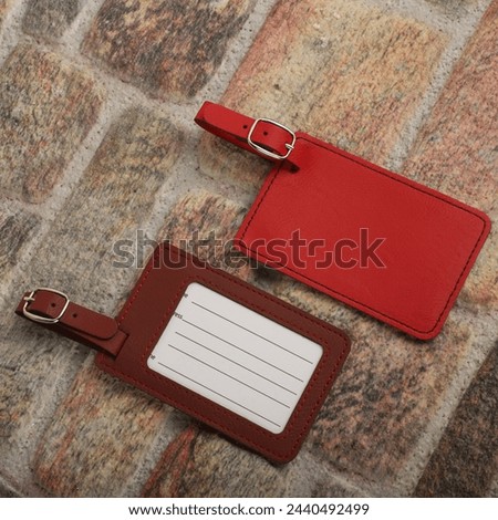 Leather luggage tags in different colors. Concept shot, top view. Custom background, luggage tags view. Empty Travel Luggage Label, Space blank for text.	