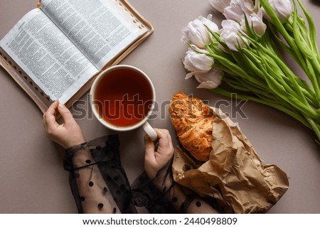 Open Bible, cup of tea and croissant, good morning.