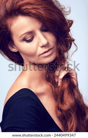 Beauty, relax and woman in studio with haircare, natural keratin glow and healthy hairstyle. Growth, shine and confident girl with red hair, wellness and luxury salon treatment on blue background