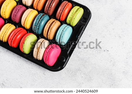 Colorful french dessert macarons with fresh fruits and nuts.