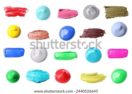 Paint blobs and strokes of different colors on white background, top view Royalty-Free Stock Photo #2440526645