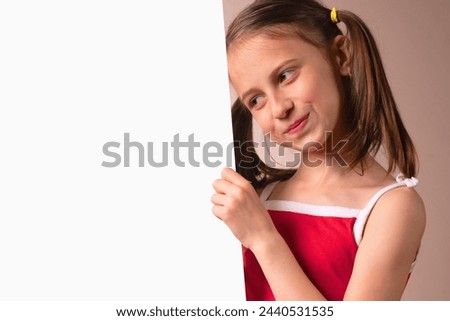 Portrait of beautiful attractive young girl behind white blank banner or empty copy space advertisement board on brown background, Copy space. Horizontal image.