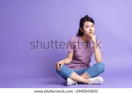 Photo of young Asian girl on purple background