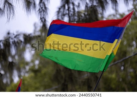 The national flag of Mauritius flutters on the lawn