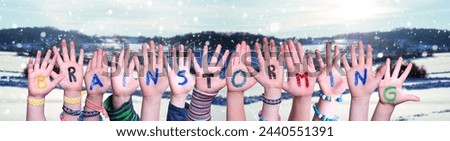 Children Hands Building Colorful English Word Brainstorming. White Winter Background With Snowflakes And Snowy Landscape.