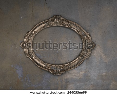 golden ancient dusty frame on a concrete wall