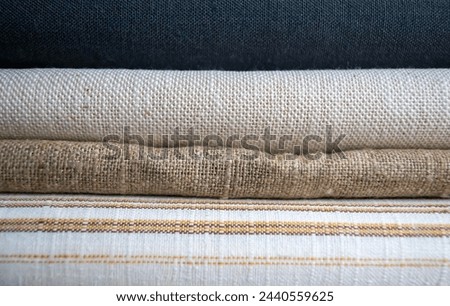 Home textiles. Different kinds of fabrics on top of each other. The fabrics are folded. Types of textiles.