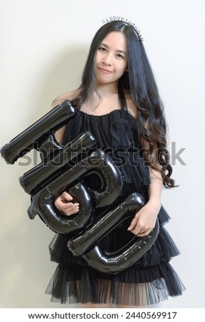 Beautiful woman wearing a black dress and chocolate cake in the concept of birthday