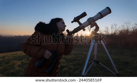 Amateur astronomer observing skies with binoculars and telescope. Royalty-Free Stock Photo #2440585169