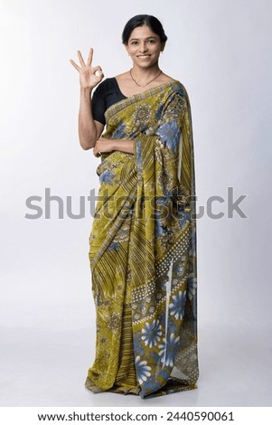  Female in saree shows okay gesture with smiling face on white background