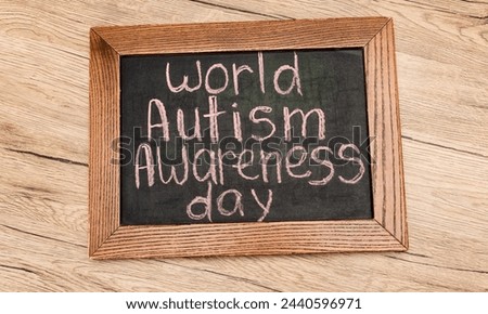 Copy space made of colorful wooden blocks on word autism wooden background, top view.Autism word concept, flat lay, image with colorful background,April 02 date related photo. Words written on a board