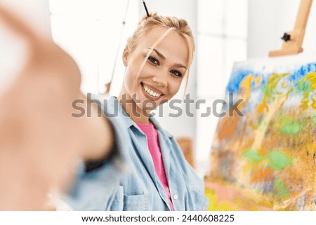 Young caucasian woman artist smiling confident make selfie by camera at art studio