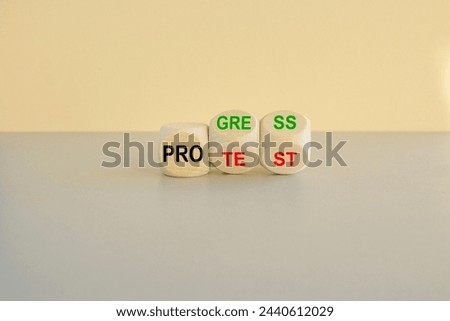 Concept red word Progress Protest on beautiful wooden cubes. Beautiful gray table beige background. Business progress vs protest concept. Copy space.