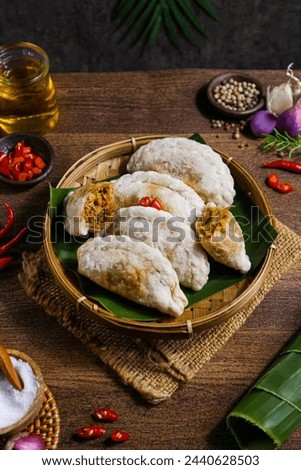 cireng filled with spicy shredded chicken on a woven bamboo plate Royalty-Free Stock Photo #2440628503