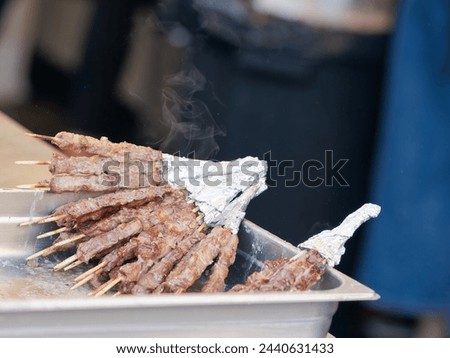 A typical central Italy dish: lamb "arrosticini". They are thin skewers of mutton cooked on the grill Royalty-Free Stock Photo #2440631433
