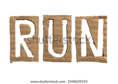 A word "RUN" crafted from a cardboard on white background with clipping path