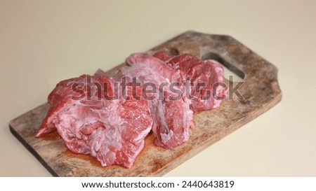 raw meat boar on a dirty cutting board