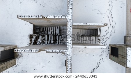 Drone photography of unfinished and abandoned building in a city covered by snow during winter cloudy day