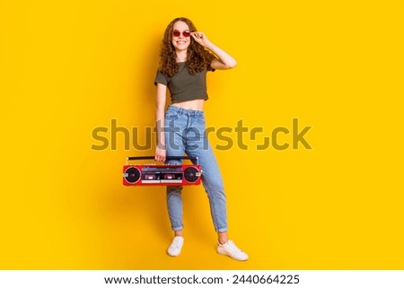 Photo of cheerful lovely girl enjoy weekend friday good mood listen music party chill isolated on vivid yellow color background