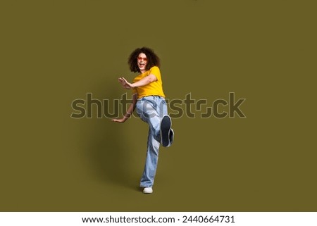 Full body size photo of millennial woman in stylish outfit chilling step toward sneakers sole brand ad isolated on khaki color background