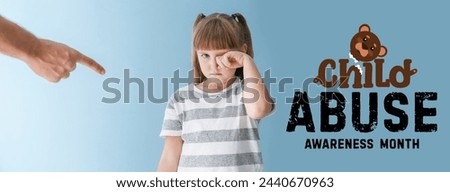 Awareness banner for National Child Abuse Prevention Month with angry father scolding his crying little daughter Royalty-Free Stock Photo #2440670963