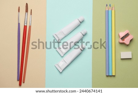 Products for children's creativity and education on a colored pastel background. Top view. Flat lay