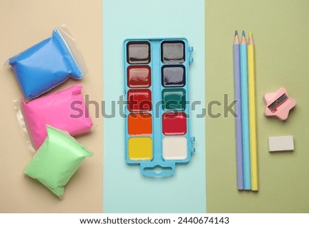 Products for children's creativity and education on a colored pastel background. Top view. Flat lay