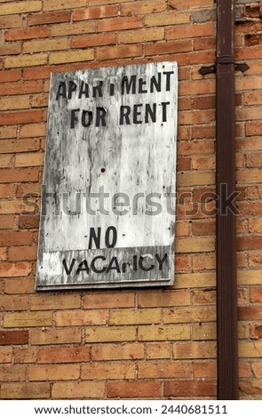 Showing an old apartment for rent sign background on an abandoned building.
