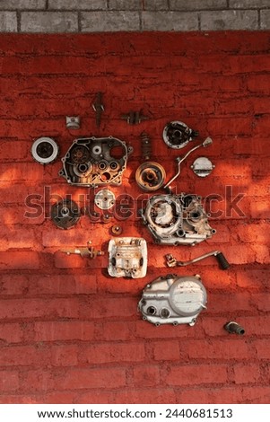  Two wheelers parts hang on the wall in Village Karjat  Maharashtra , India. Royalty-Free Stock Photo #2440681513