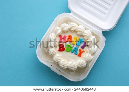 Mini birthday cake with colorful happy birthday message in a cardboard lunch box