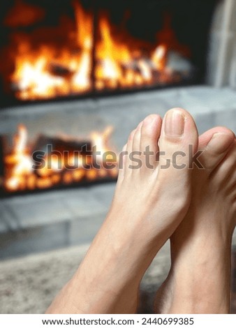 Photo of woman barefoot with blur fireplace background