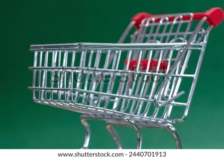 shopping trolley on the green background