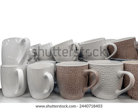 Ceramic mugs of various shapes stacked isolated on white copy space,  with clipping path included
