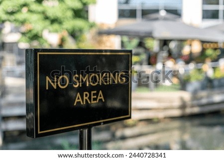 No smoking area sign outside in the street