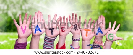Children Hands Building Colorful German Word Vatertag Means Fathers Day. Summer, Sunny Green Grass Meadow As Background