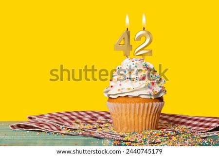 Birthday Cake With Candle Number 42 - Photo On Yellow Background.