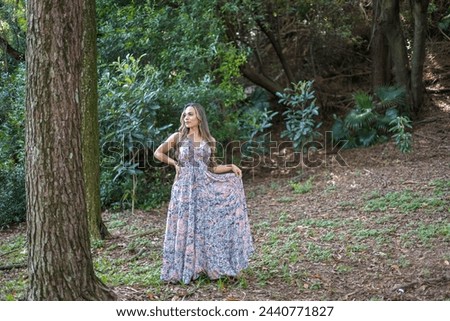 woman walking and dancing through the woods collecting herbs and smelling them. Walking free and uninhibited.