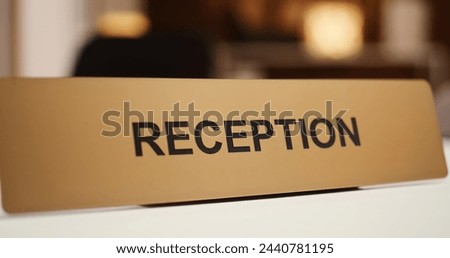 Extreme close up of luxury modern hospitality industry resort check in reception counter sign. Empty clean front desk in stylish travel accommodation resort lounge interior