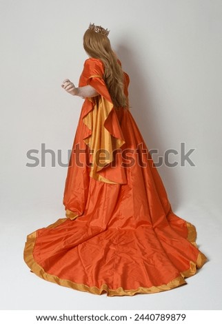 Full length portrait of plus sized woman blonde hair, wearing historical medieval fantasy gown, golden crown of royal queen. Standing pose, walking away in silhouette, isolated studio background.