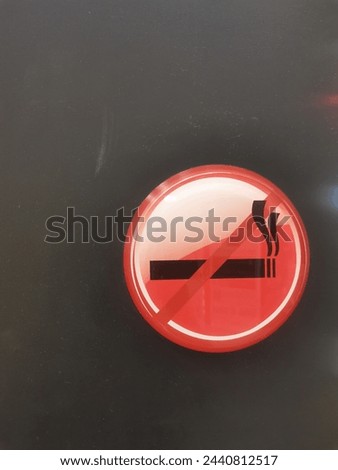 red no smoking sign on a dark wall