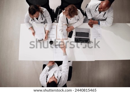 Young Doctor Sitting At Job Interview In Hospital