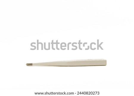 White digital thermometer isolated on white background with copy space. Close-up, side view.