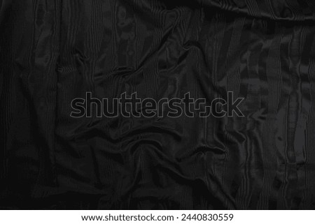 Texture of black taffeta (silk) fabric with black stripes pattern, top view. Background, texture of draped dressy fabric with shining black stripes pattern. Royalty-Free Stock Photo #2440830559