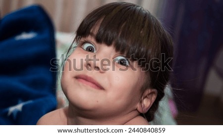 Little girl with surprised expression close up portrait