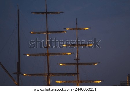 Sails unfurled in the night It is a beautiful and peaceful picture. The white sails shimmered in the moonlight. The black sky was dotted with twinkling stars.