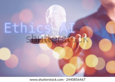 A person holding a cell phone with the words Ethics AI and robot hologram, Concept of the importance of ethical AI and the responsibility of those who create and use it