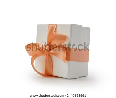 White gift box with orange ribbon bow isolated on white background
