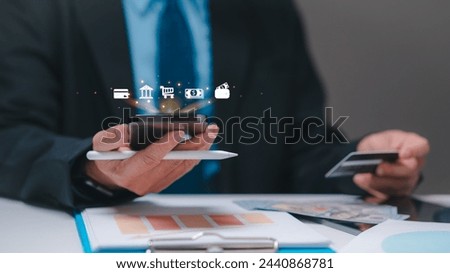 A manager is holding a cell phone and a credit card, with a picture of a wallet on the screen. Concept of financial transactions and the importance of managing one's finances. shopping online