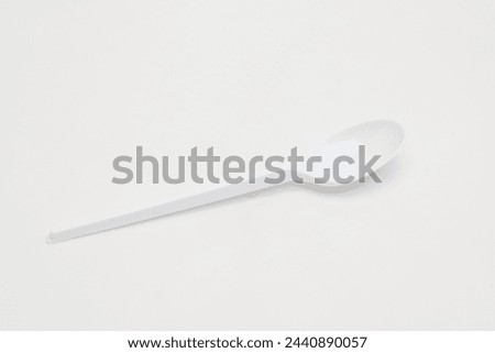 Plastic disposable spoon on a white background.